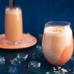 Carrot, banana and yoghurt smoothie with a coco and nut topping